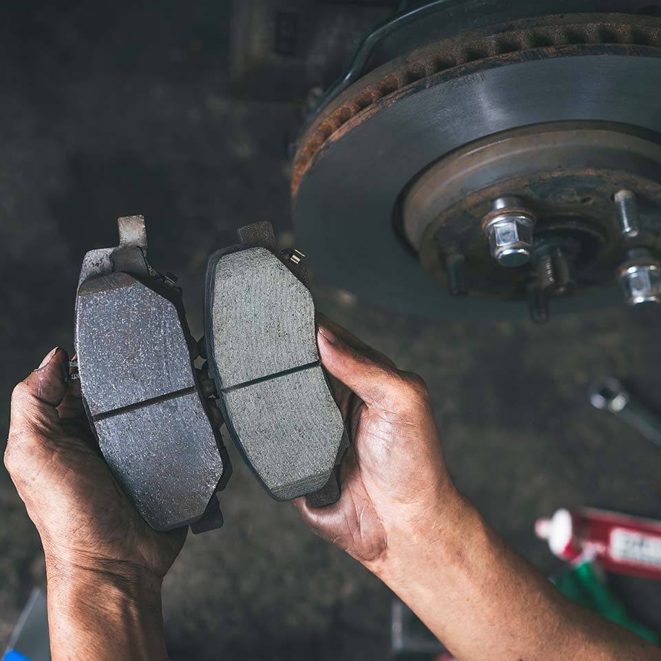 New car brake pads compared to old used brake pads.