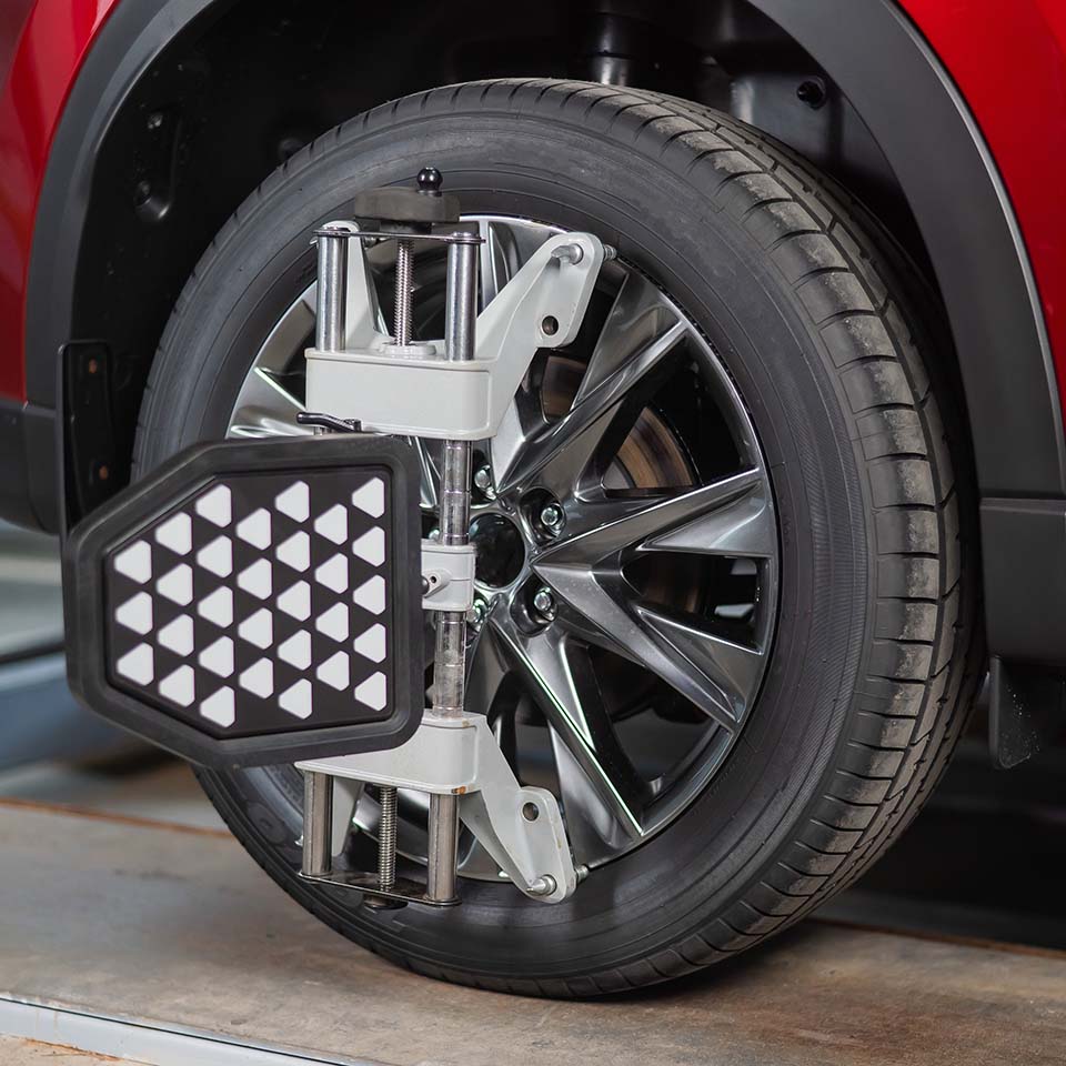 Alignment of car wheels in a car service.